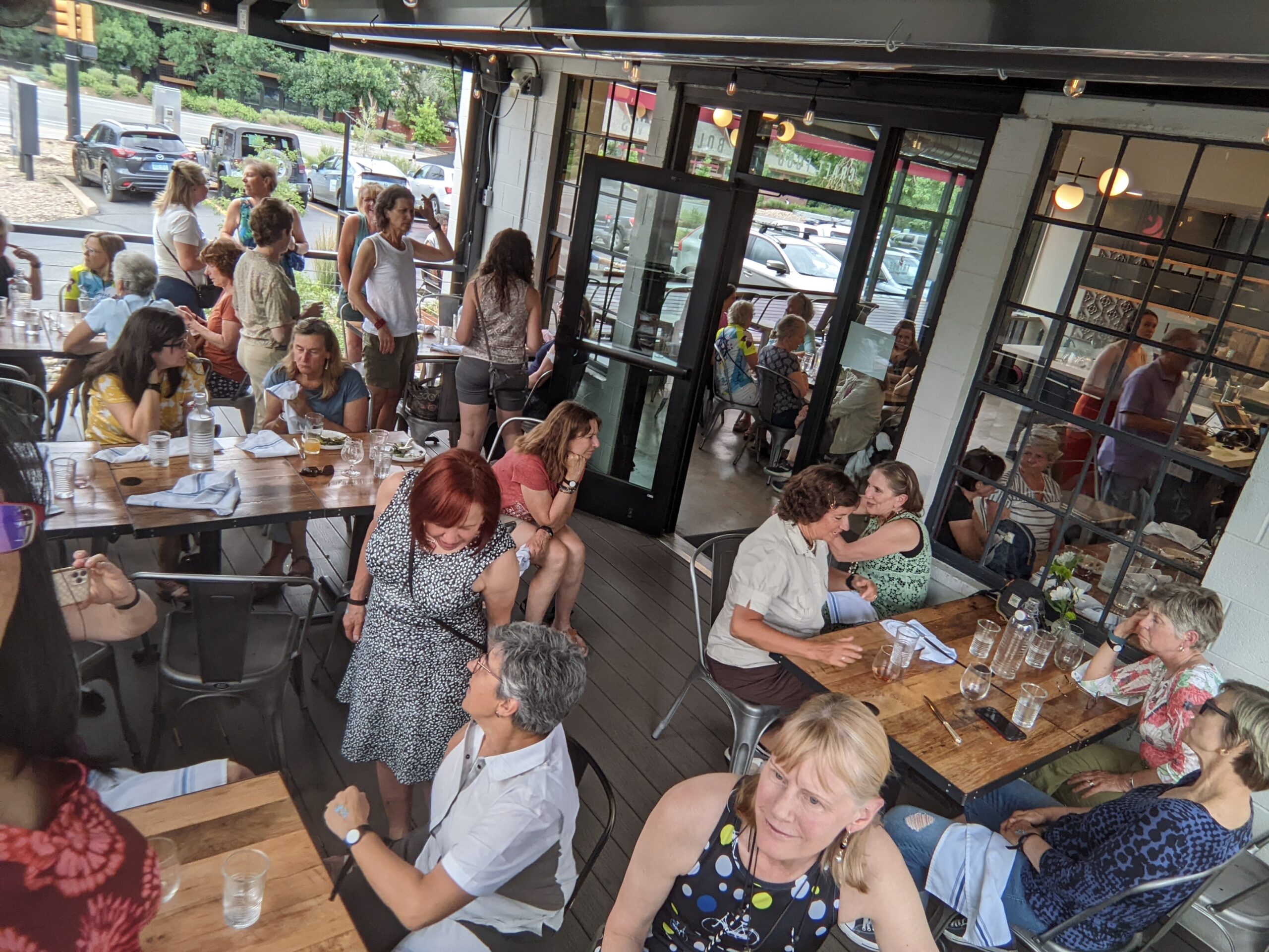 Overhead photo of club members seated on an outdoor patio chatting