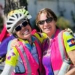 Two Venus ride coordinators wearing bright pink safety vests