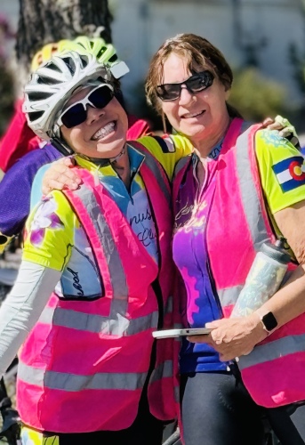 Two Venus ride coordinators wearing bright pink safety vests