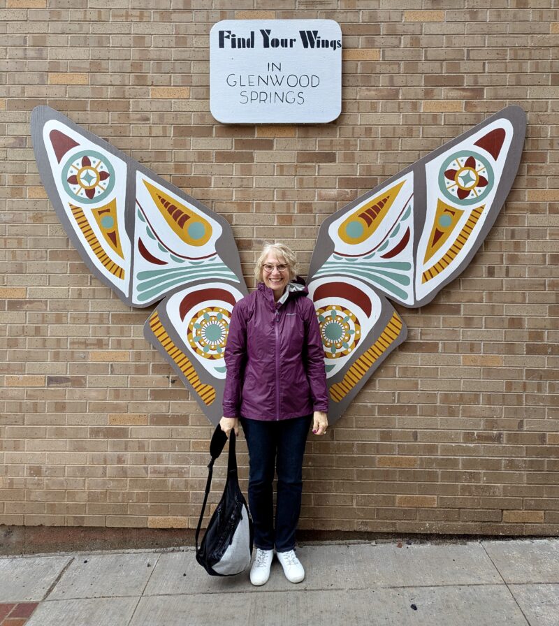 Venus sister posing in front of winged art