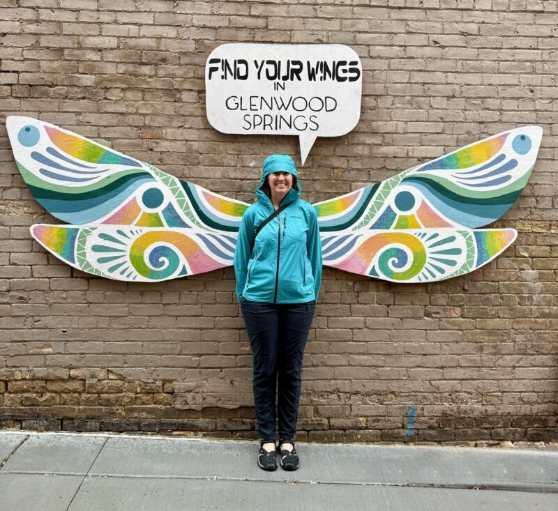 Venus sister posing in front of winged art