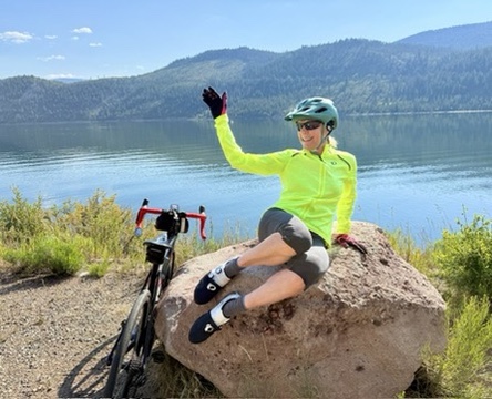 Venus member posing as a mermaid on a rock in front of Lake Dillon