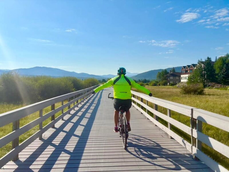 Biker riding along a pedestrian bridge