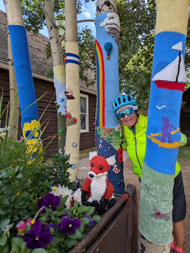 Venus member posing with sweater art trees