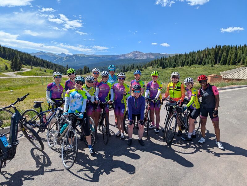 Over a dozen Venus Bike Club members at the top of Vail Pass