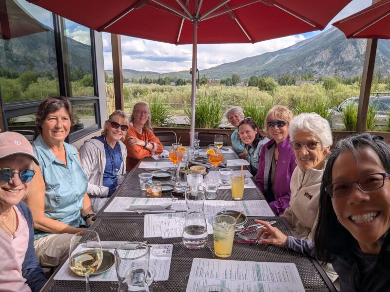 Venus gals sitting around a table for happy hour