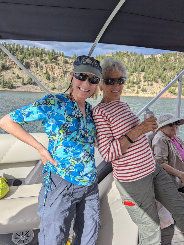 Two Venus members on a pontoon, smiling